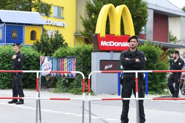 Police forces stand in front of the McDonald's restaurant where the shooting spree started near Olympia shopping center (OEZ) in Munich, Germany, 23 July 2016