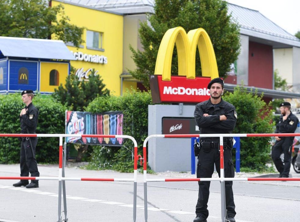 Police forces stand in front of the McDonald's restaurant where the shooting spree started near Olympia shopping center (OEZ) in Munich, Germany, 23 July 2016