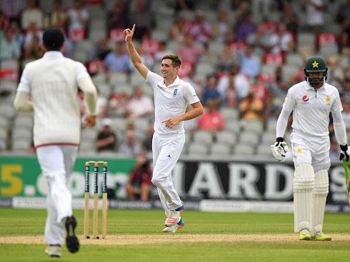 Chris Woakes celebrates taking a catch off his own bowling to remove Azhar Ali late on day two (Getty)
