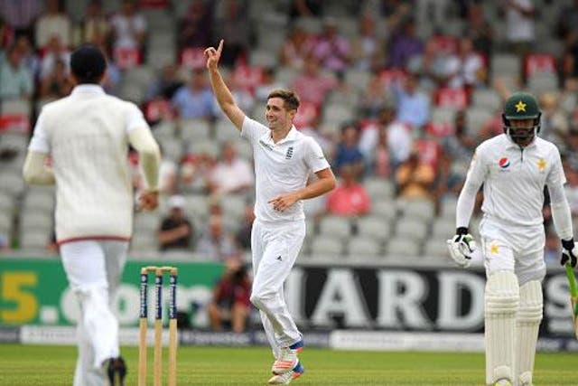 Chris Woakes celebrates taking a catch off his own bowling to remove Azhar Ali late on day two (Getty)