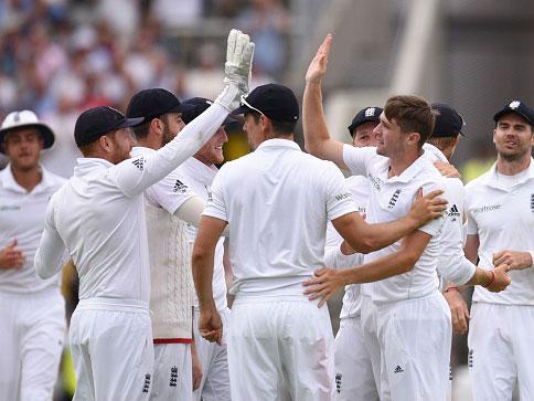 Chris Woakes is congratulated by his team-mates after taking the wicket of Mohammad Hafeez (Getty)