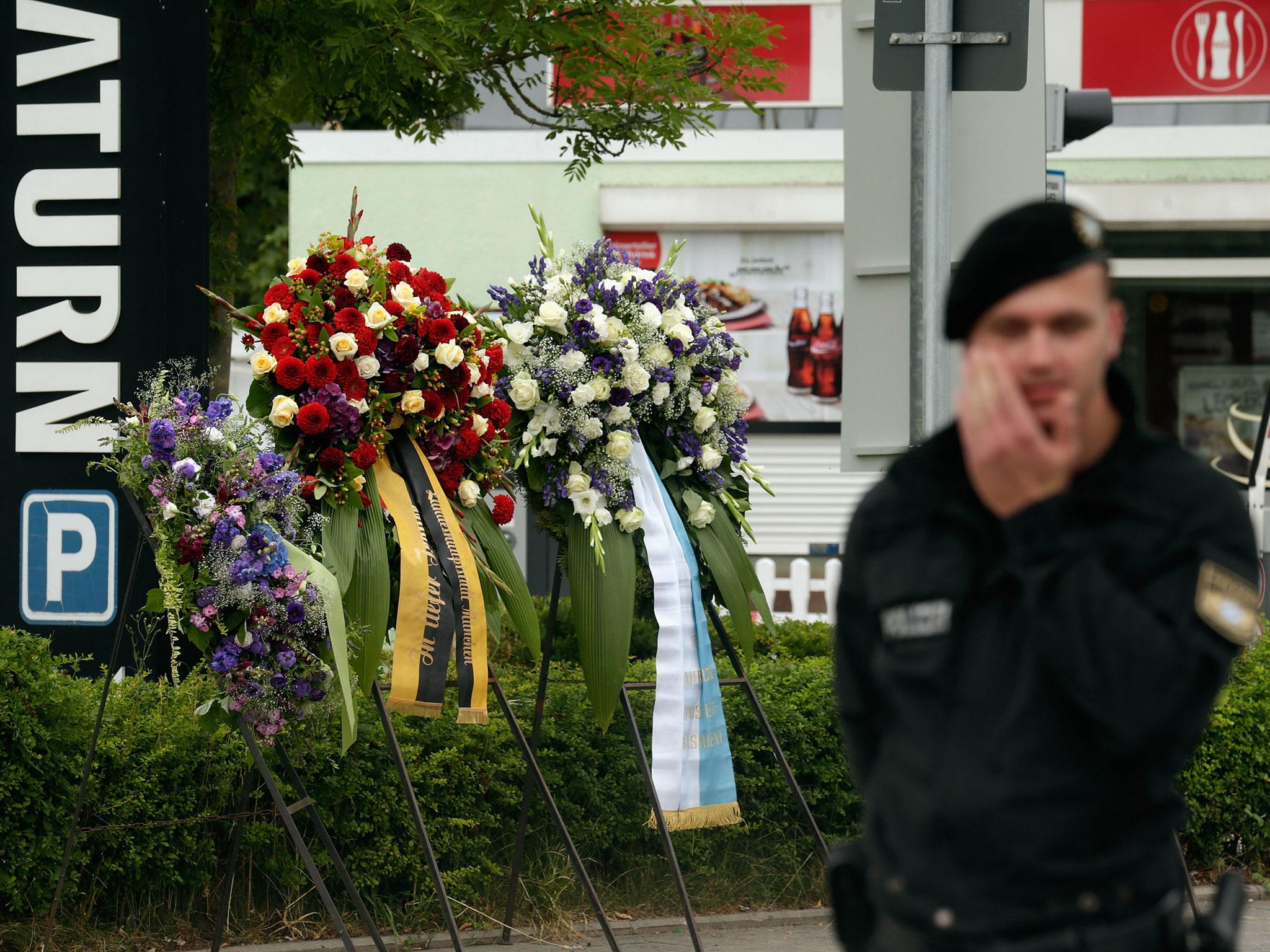 A police officer guards the scene of the attack where nine people died