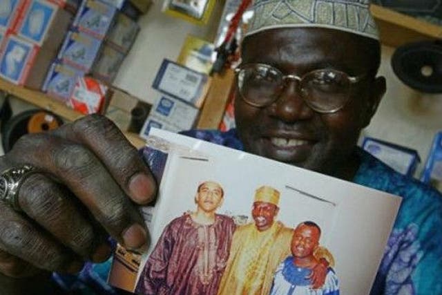 Malik Obama holds a photograph showing him and his brother