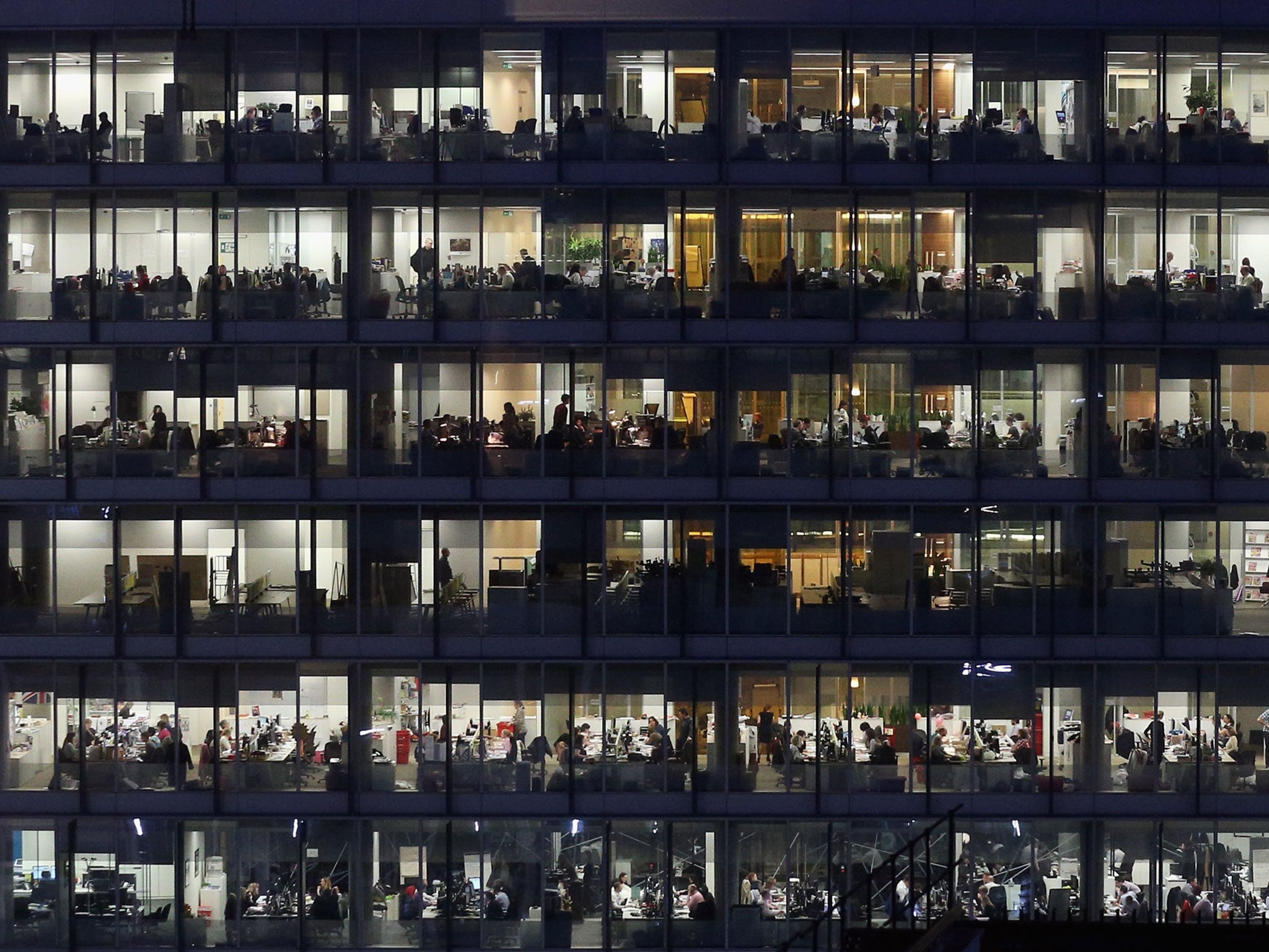 Office workers work into the night at their offices in Southwark, London