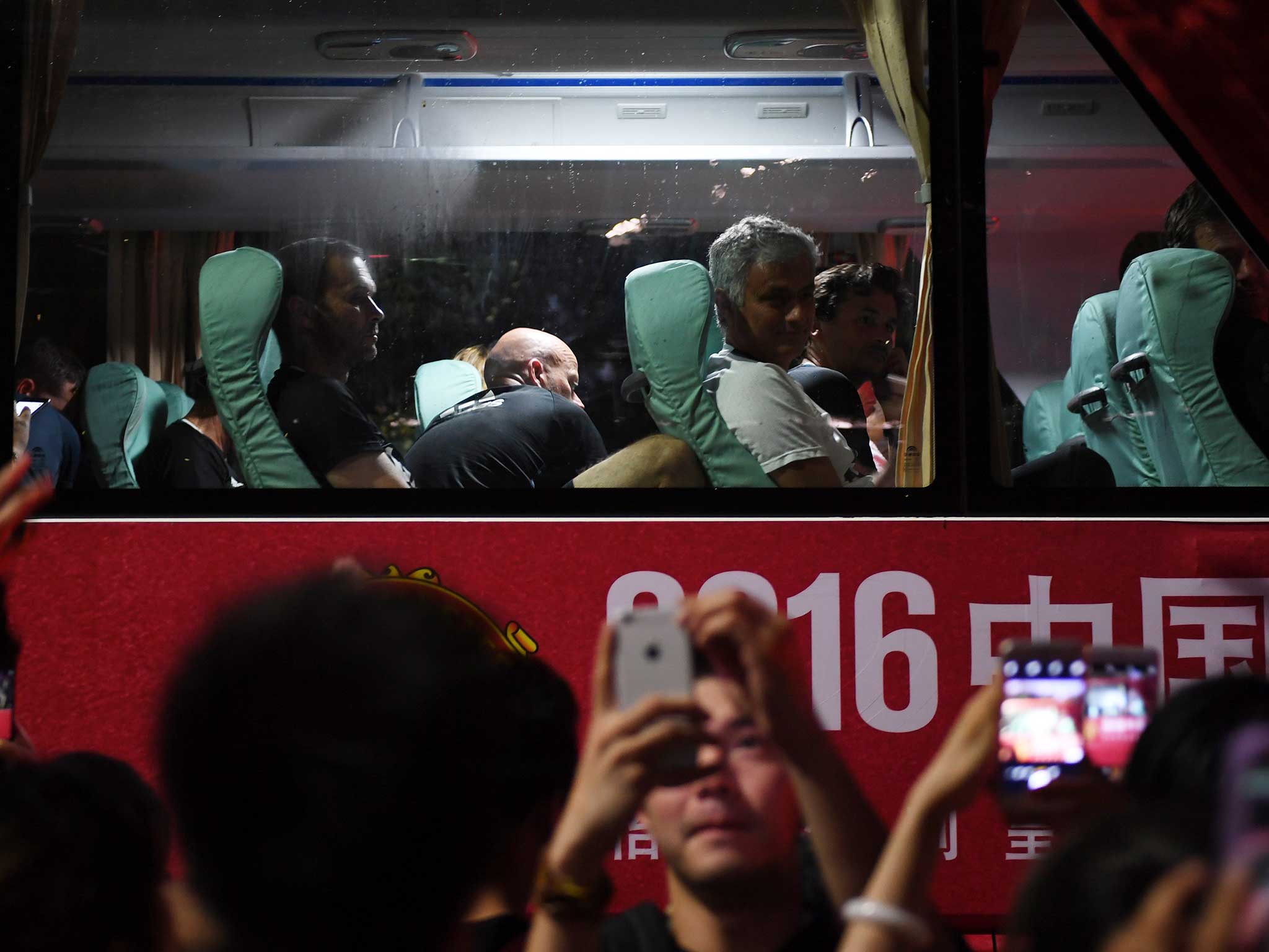 Jose Mourinho and his players leave after another hectic day in China