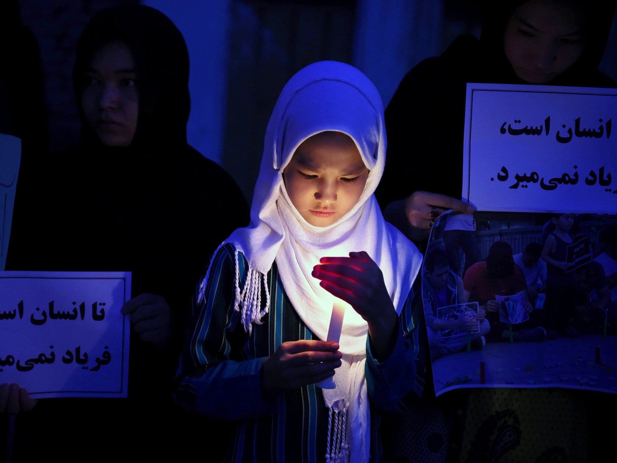 The rocket attack on the school in Kabul came as people were mourning the 80 killed in a separate suicide attack in the city on Saturday. Above, a girl from the Hazara community in Pakistan at a vigil for their fallen compatriots in Afghanistan