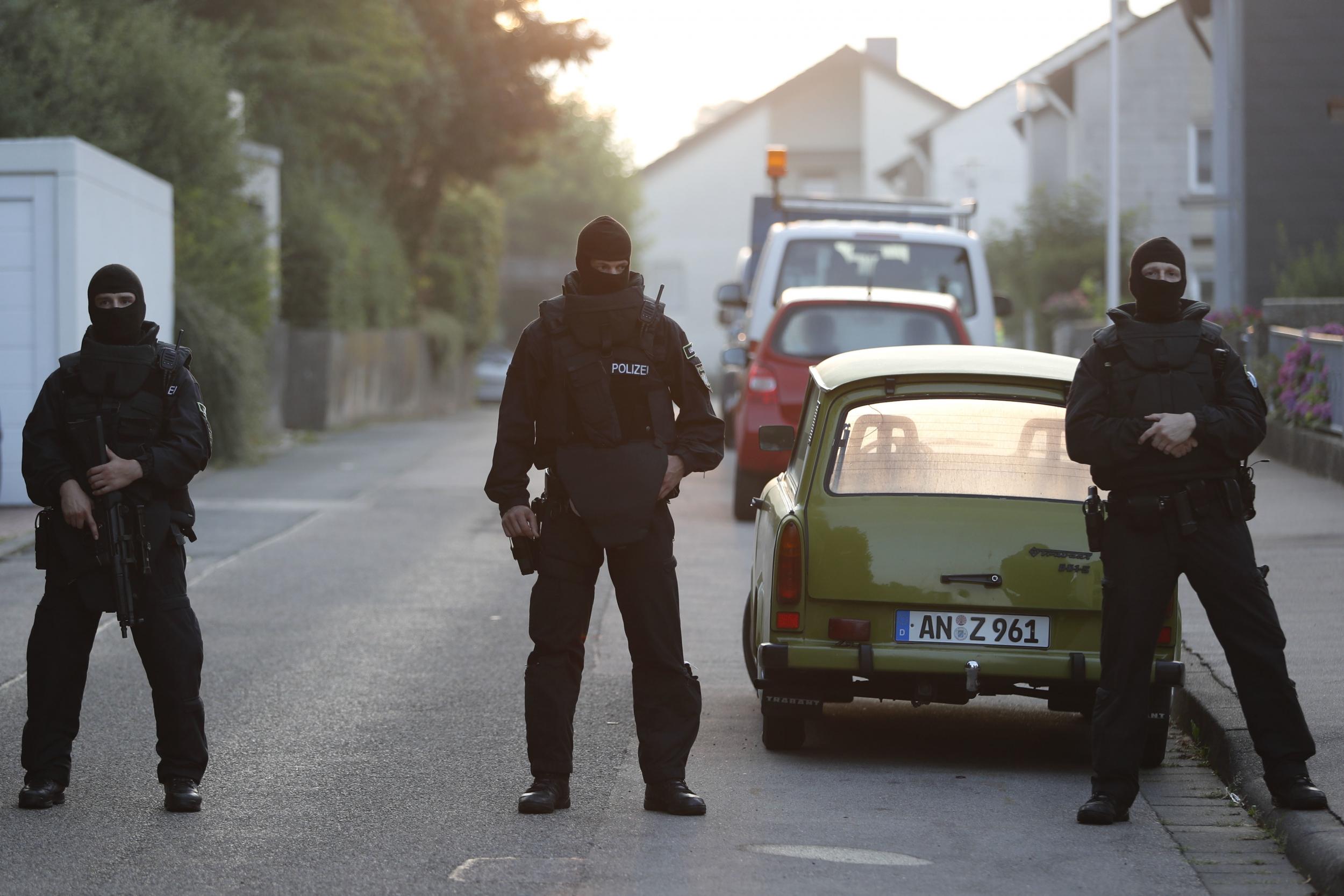 Special police officers secure a street near the house where a Syrian man lived before the explosion in Ansbach