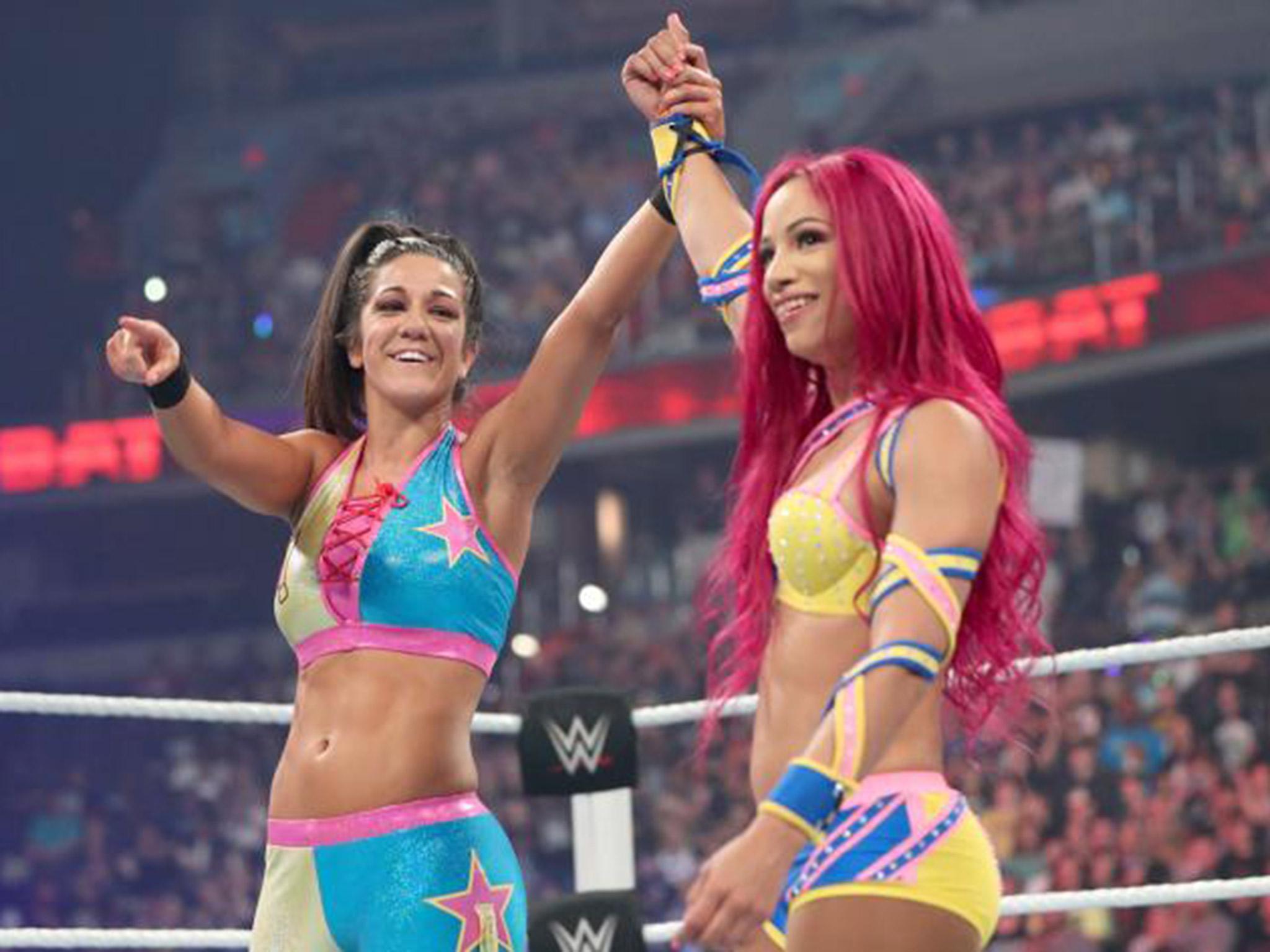 Bayley and Sasha Banks celebrate after beatin Charlotte and Dana Brooke (WWE.com)