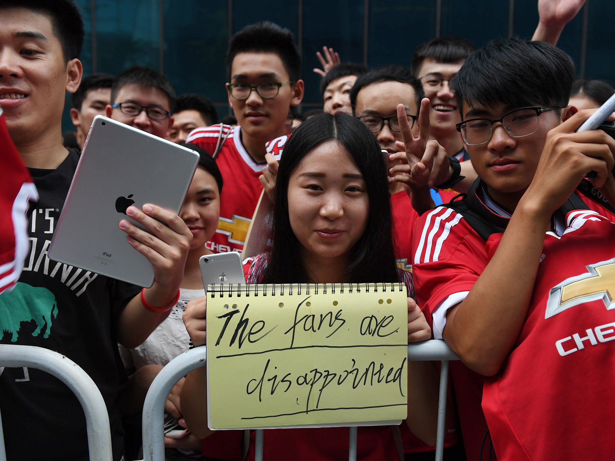 Fans of Manchester United display their frustration after the derby with Manchester City is called off