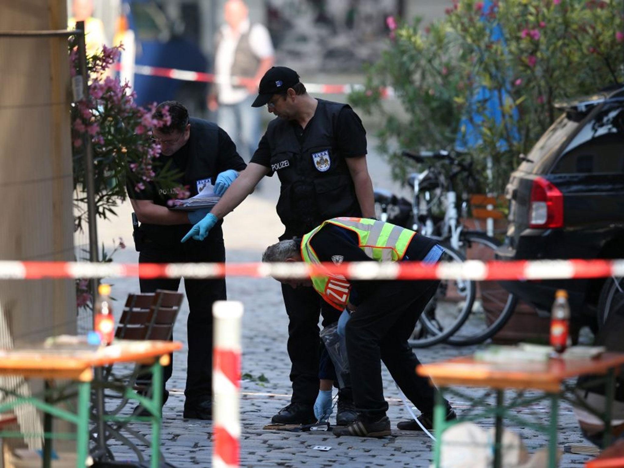 Police officers operate on a scene following an explosion in Ansbach, Germany, 25 July, 2016