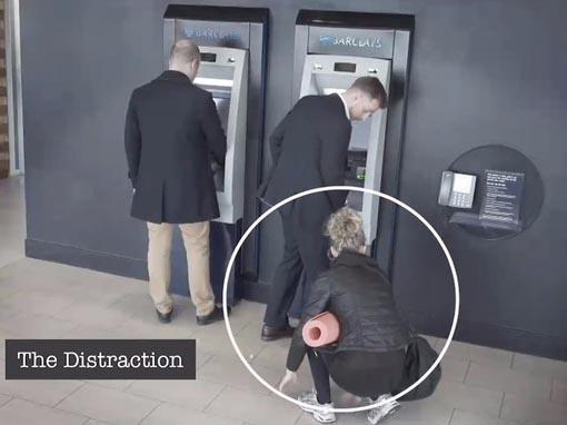 &#13;
The video shows a woman distracting the victim from his transaction.&#13;