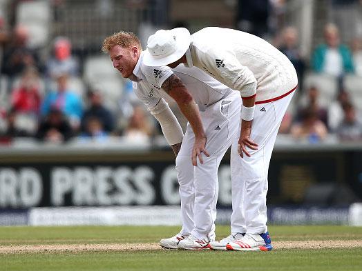 Stuart Broad checks on the well-being of Ben Stokes during the fourth day at Old Trafford (Getty)