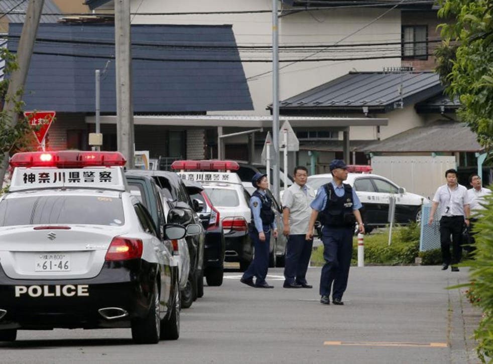 Japanese police officers check around a residential care facility (part of the facility tower is seen in rear) for disabled people in Sagamihara, Kanagawa Prefecture, about 60km west of Tokyo, Japan, 26 July, 2016