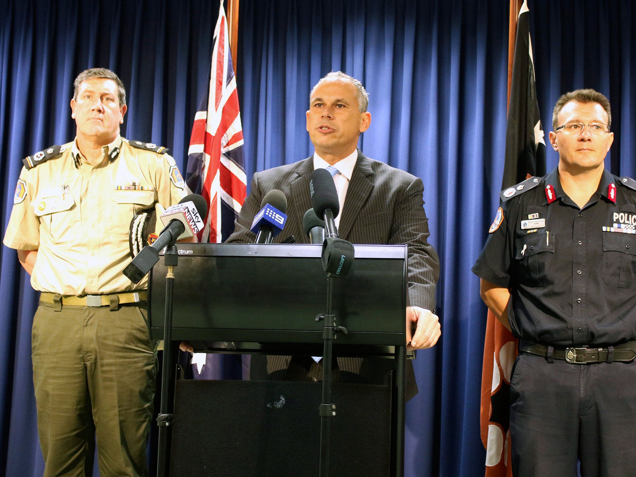 Northern Territory Chief Minister Adam Giles, Corrections Commissioner Mark Payne (L) and Police Commissioner Reece Kershaw in Darwin on 26 July