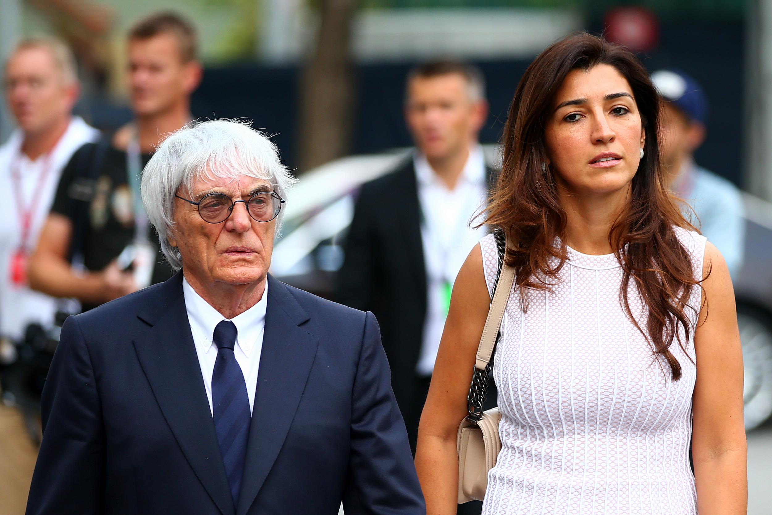 Bernie Ecclestone walks through the paddock with his wife Fabiana Flosi. Ms Flosi's mother has reportedly been kidnapped