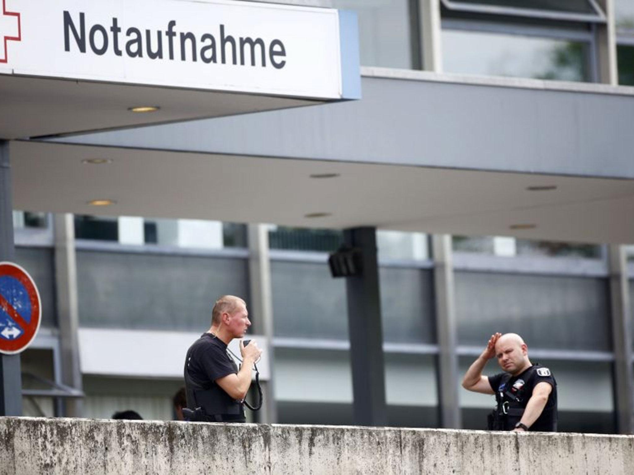 Police stand outside the university clinic in Steglitz, a southwestern district of Berlin, 26 July, 2016, after a doctor had been shot at and the gunman had killed himself