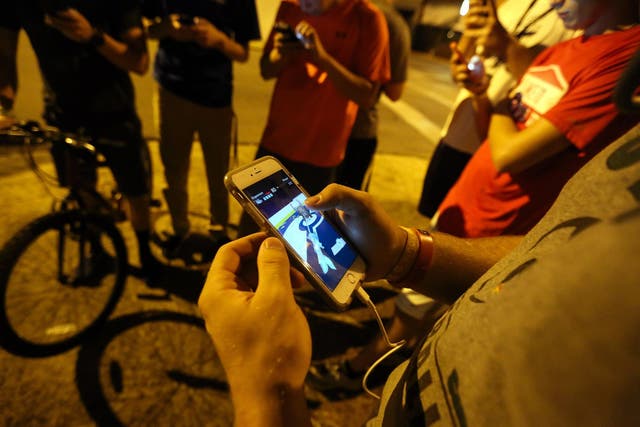 A group of teenagers play "Pokemon Go"