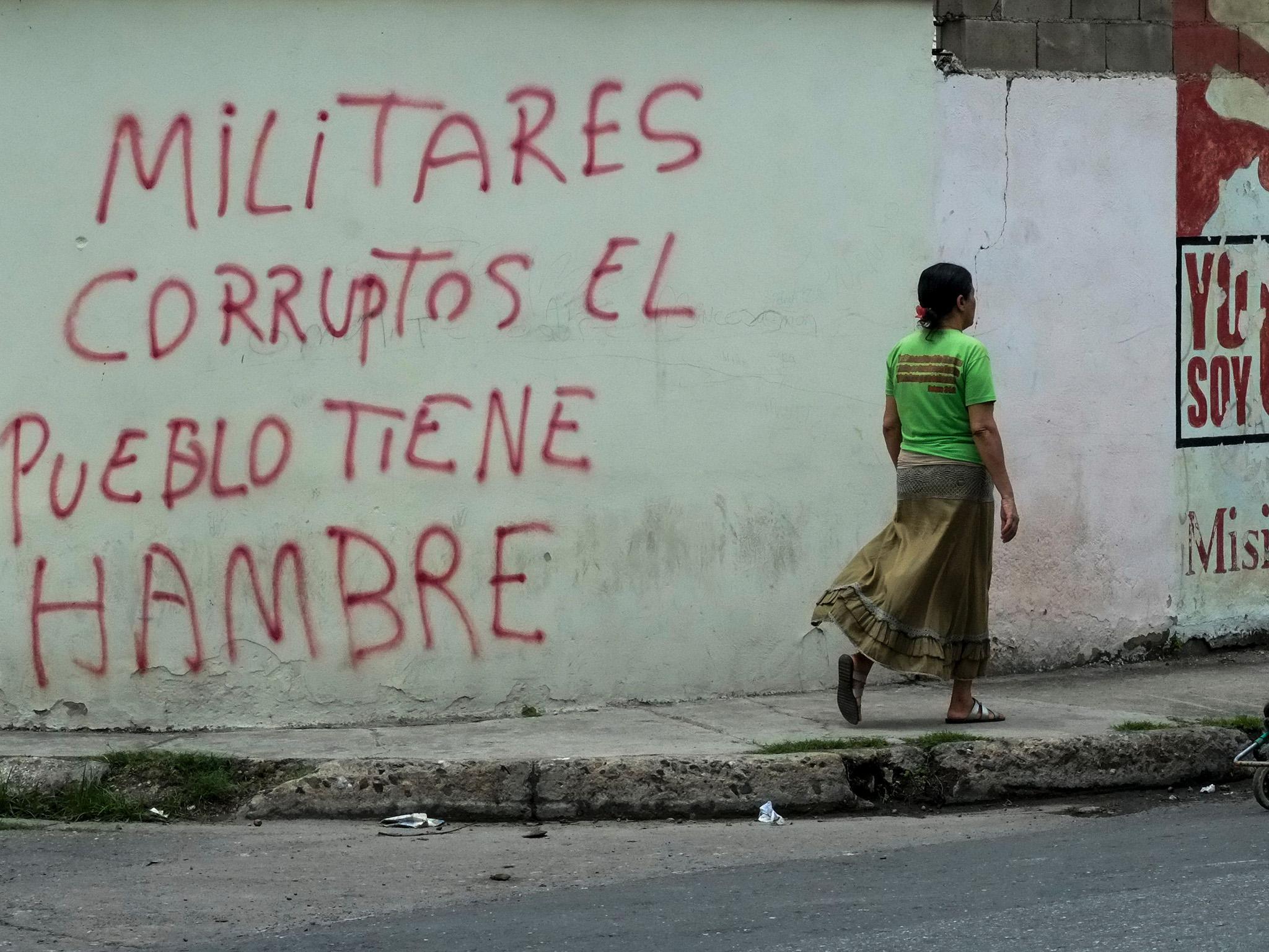 A inscription on a wall in the low income Santa Rita neighborhood in Maracay, 70km from Caracas, reads "Corrupt military, the people is hungry"