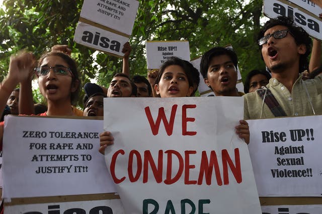 Indian students shout slogans during a protest against the rapes of two minor girls outside the police headquarters in New Delhi on October 18, 2015