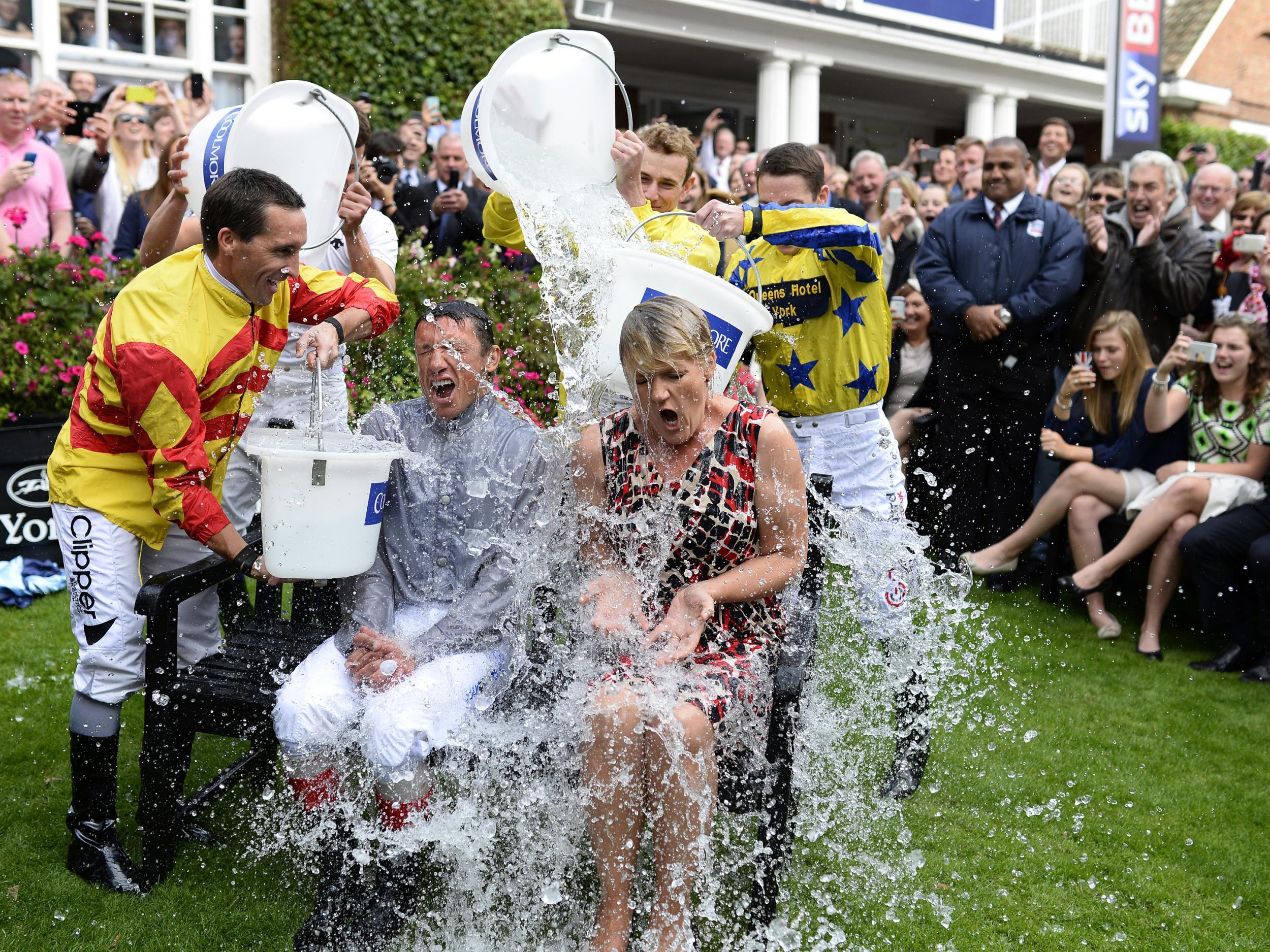 Frankie Dettori and Clare Balding take part in the ‘Ice Bucket Challenge’ at York racecourse on August 22, 2014.