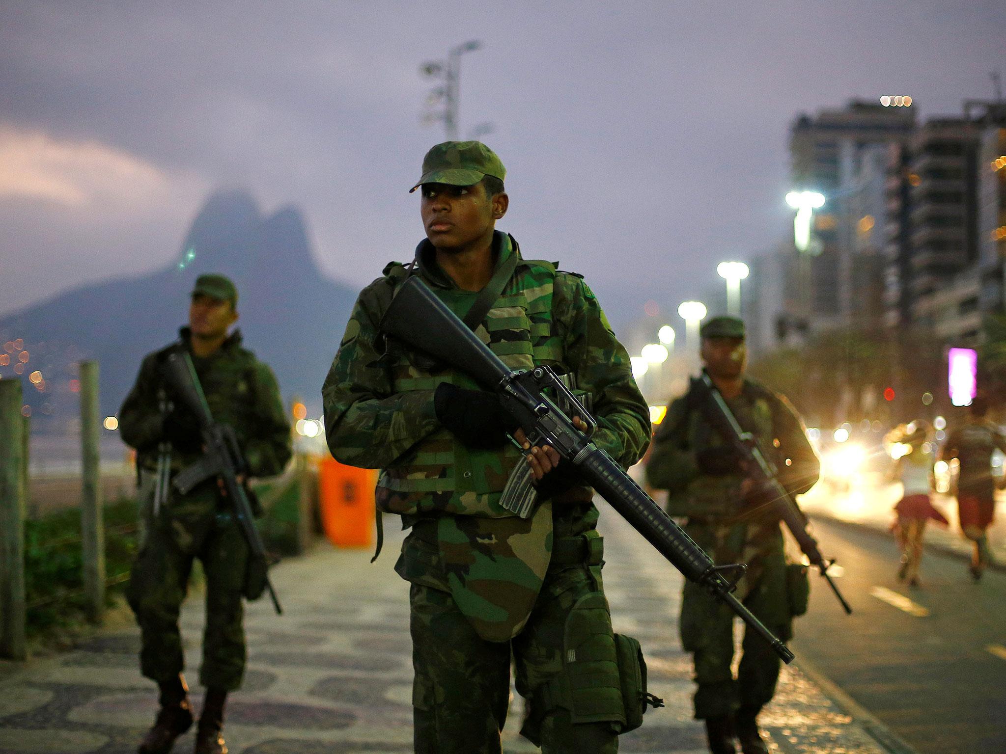 Brazilian soldiers patrol along Ipanema Beach ahead of the Rio 2016 Olympic Games in Rio de Janeiro