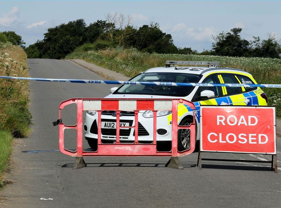 Police close a road close to RAF Marham in Norfolk, after a serviceman was threatened with a knife near to the base