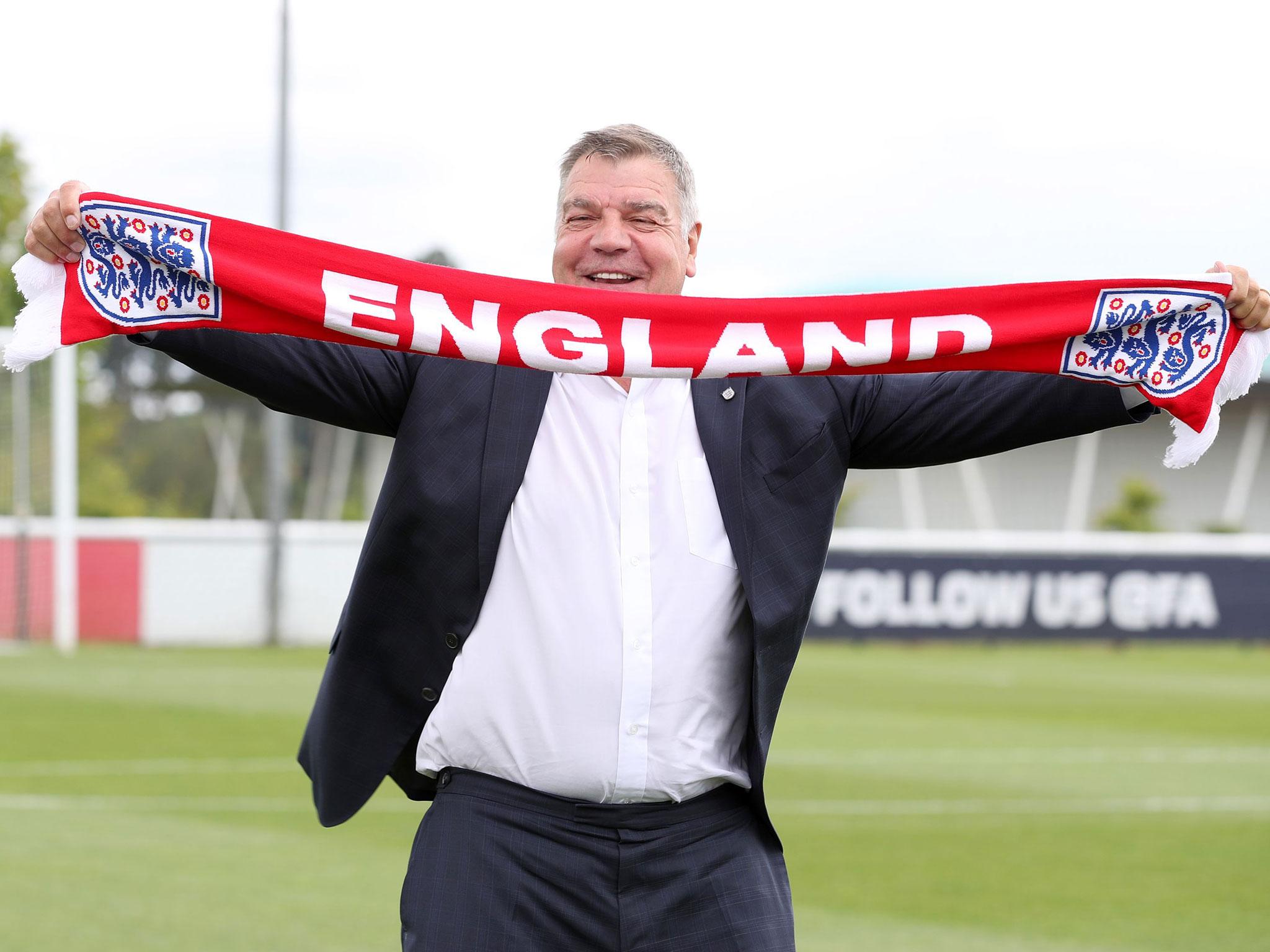 Tthe England football team, Sam Allardyce poses for a photograph with an England scarf