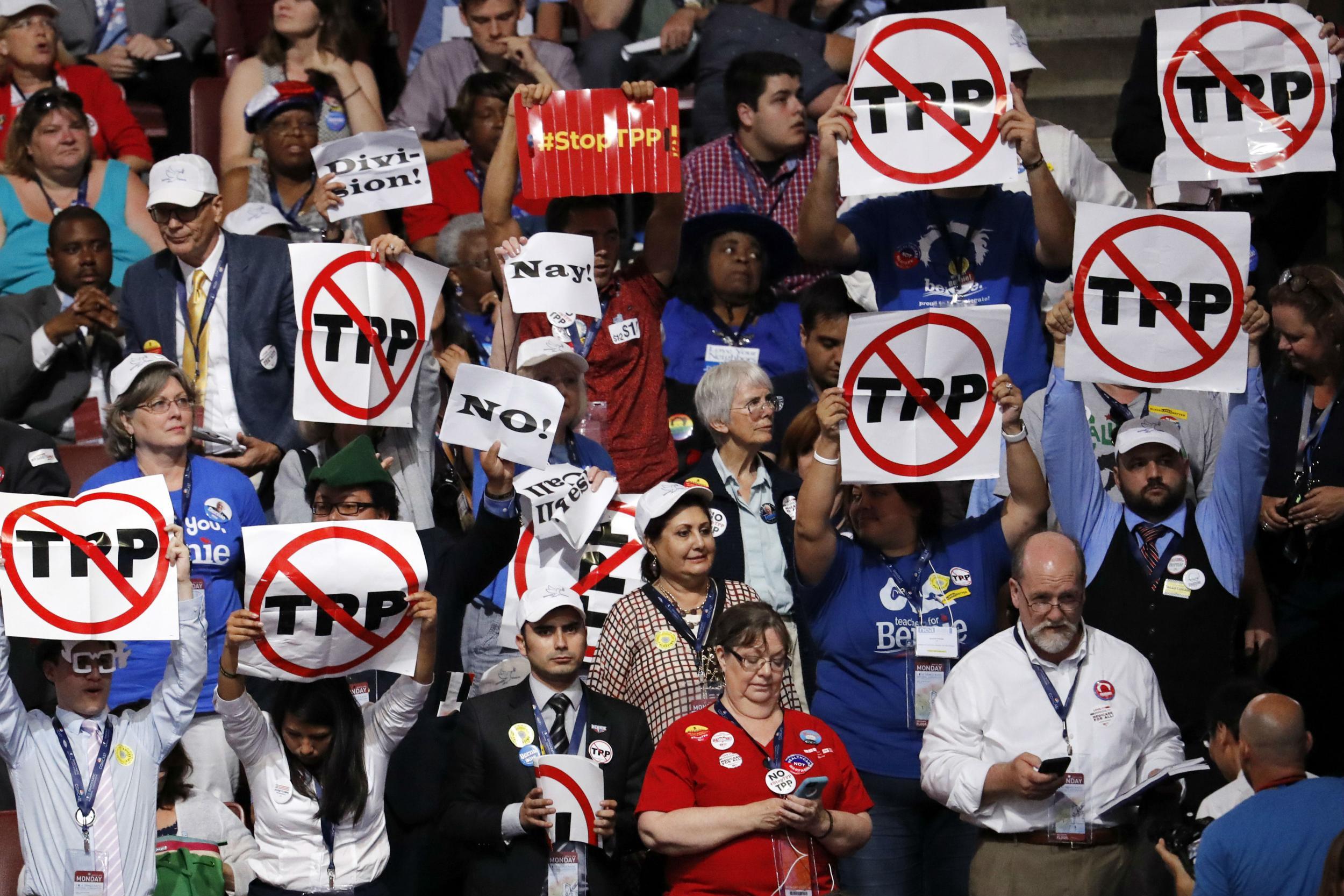 Delegates protest the Trans-Pacific Partnership on convention floor
