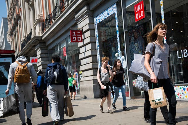 Shoppers carry bags with purchases on Oxford Street during the sales in June