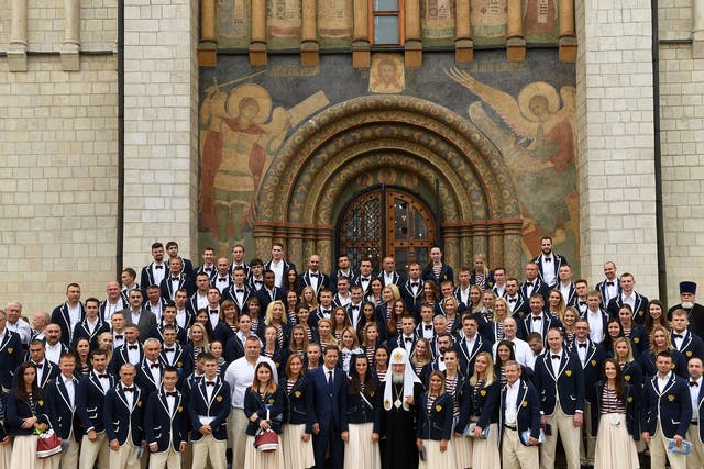 Russia's Olympic team pose for a photograph at Sobornaya Square in Moscow's Kremlin before departing for Rio