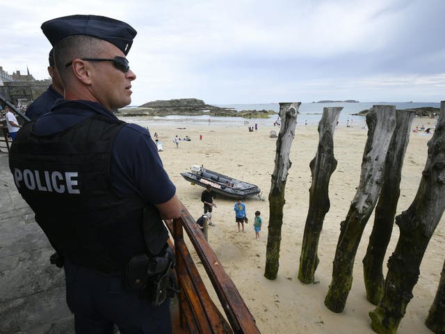 French anti-riot policemen (CRS - compagnie Republicaine de Securite) patrol close to the beach of Saint-Malo, western France on July 21, 2016