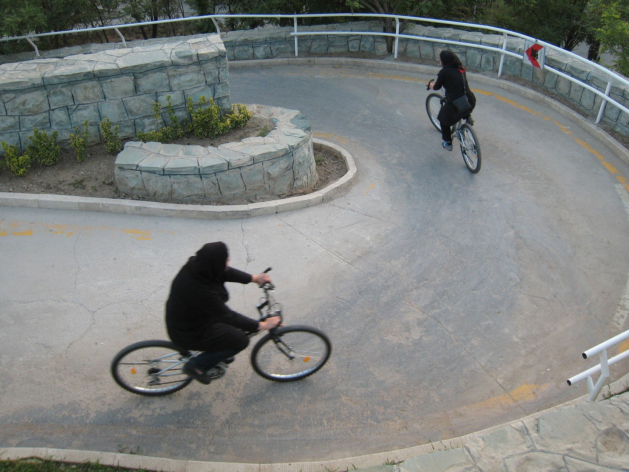Iranian women ride their bicycles at Tehran's 'Mothers' Paradise' park, which is the Iranian capital's women-only public recreation area, on June 13 2008.
