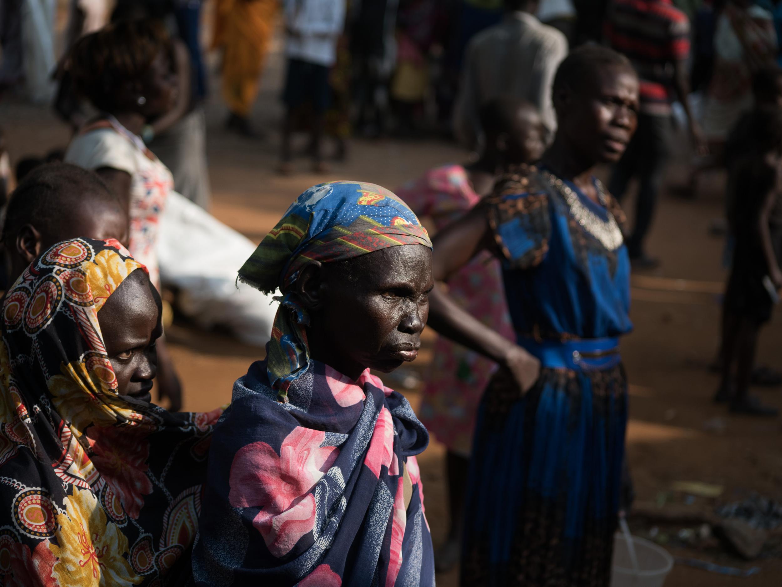 Families wait after they have find shelter in Saint Joseph's church compound in Juba earlier this month