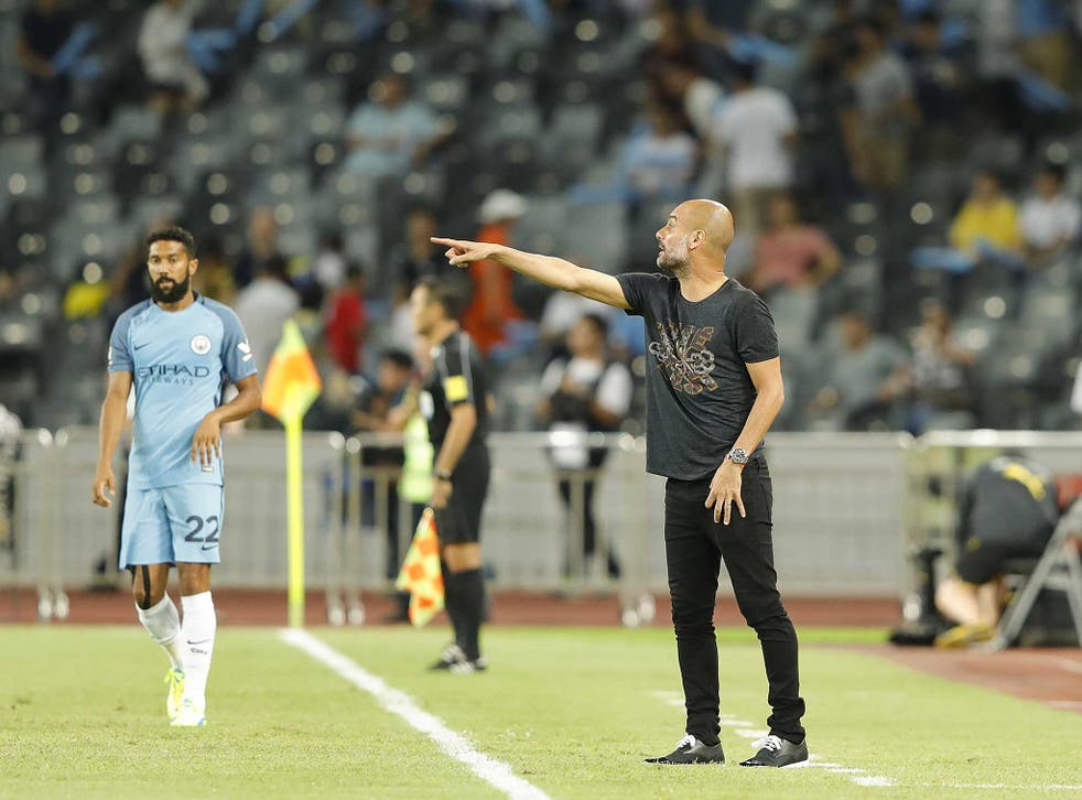 Pep Guardiola instructs his Manchester City players during the pre-season fixture with Borussia Dortmund