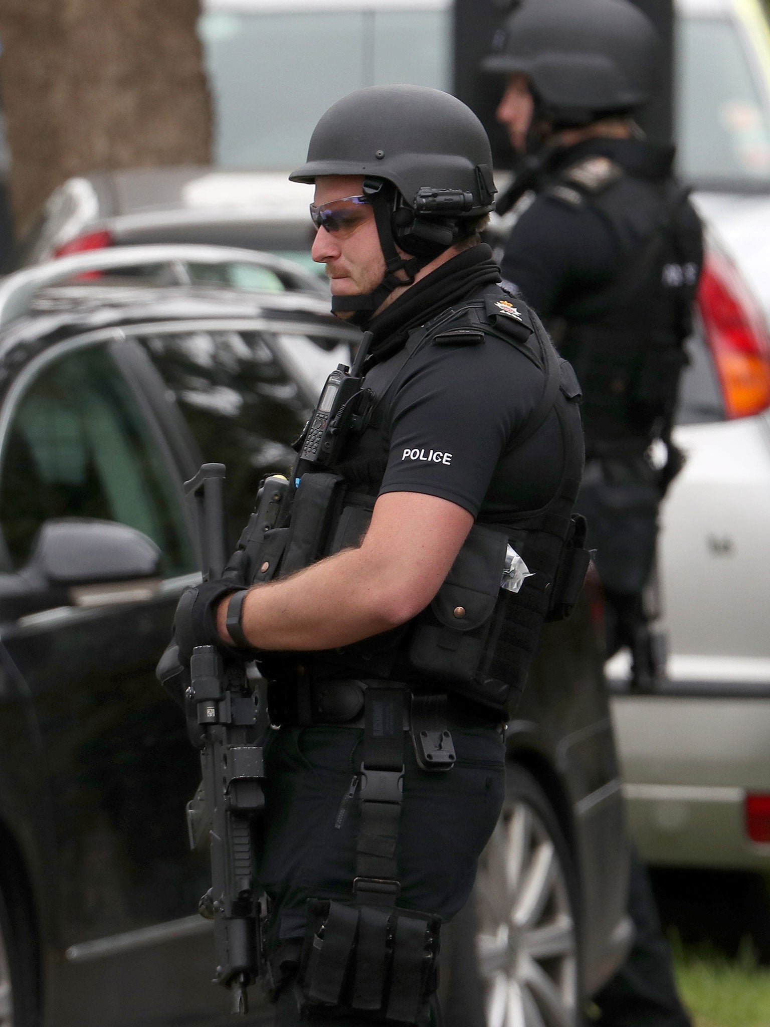 Armed police at the scene in Smallfield, Surrey, after reports someone was seen with a firearm during a dawn raid.