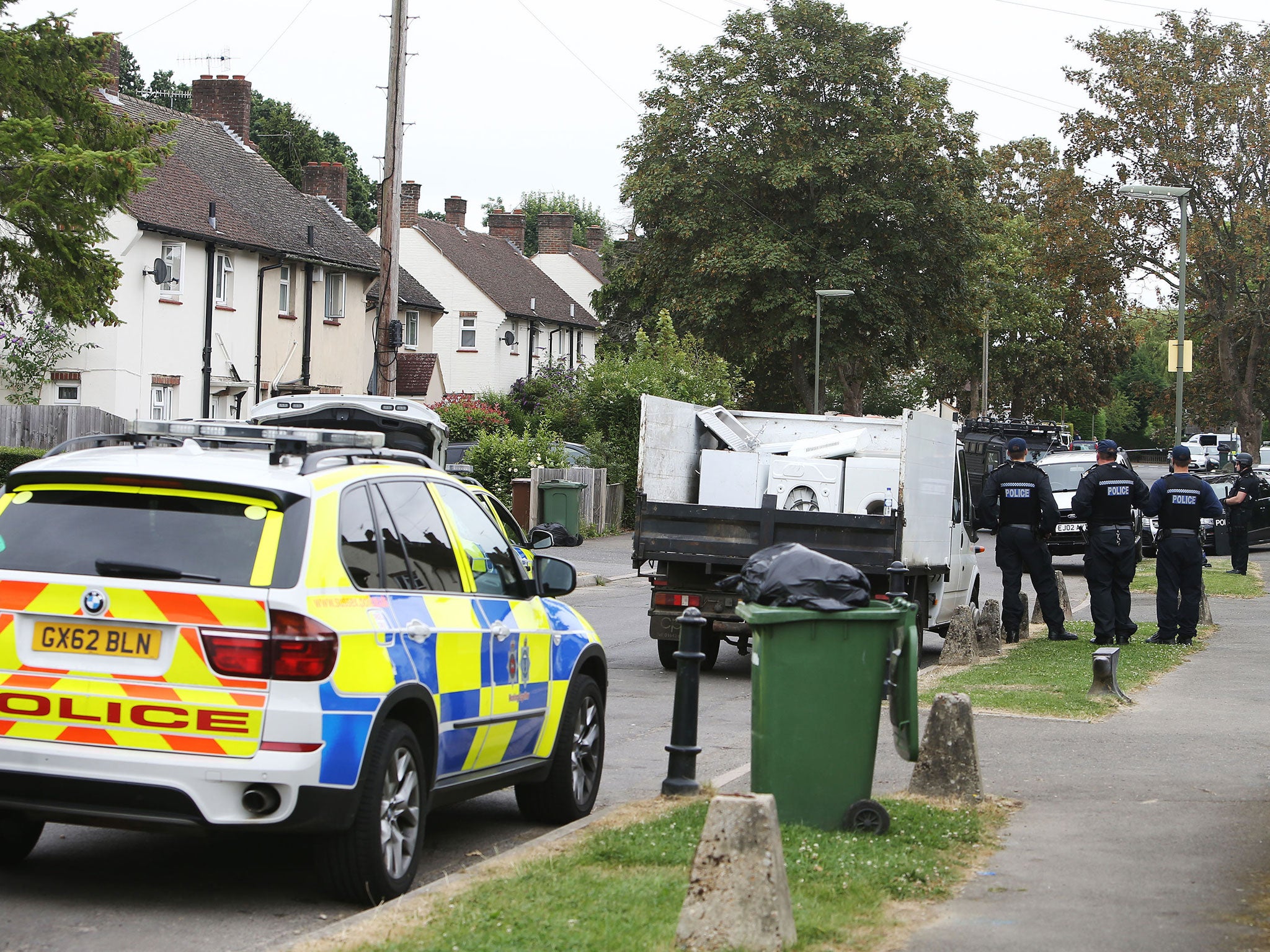 Armed police at the scene in Smallfield, Surrey, after reports someone was seen with a firearm during a dawn raid.