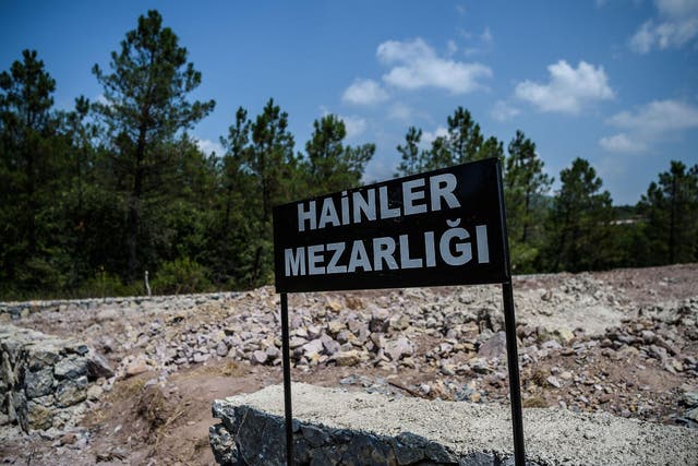 A sign reading 'Traitors' Cemetery' in Turkish is seen in front of unmarked graves built specially by the Istanbul municipality for those who died during the country's failed coup