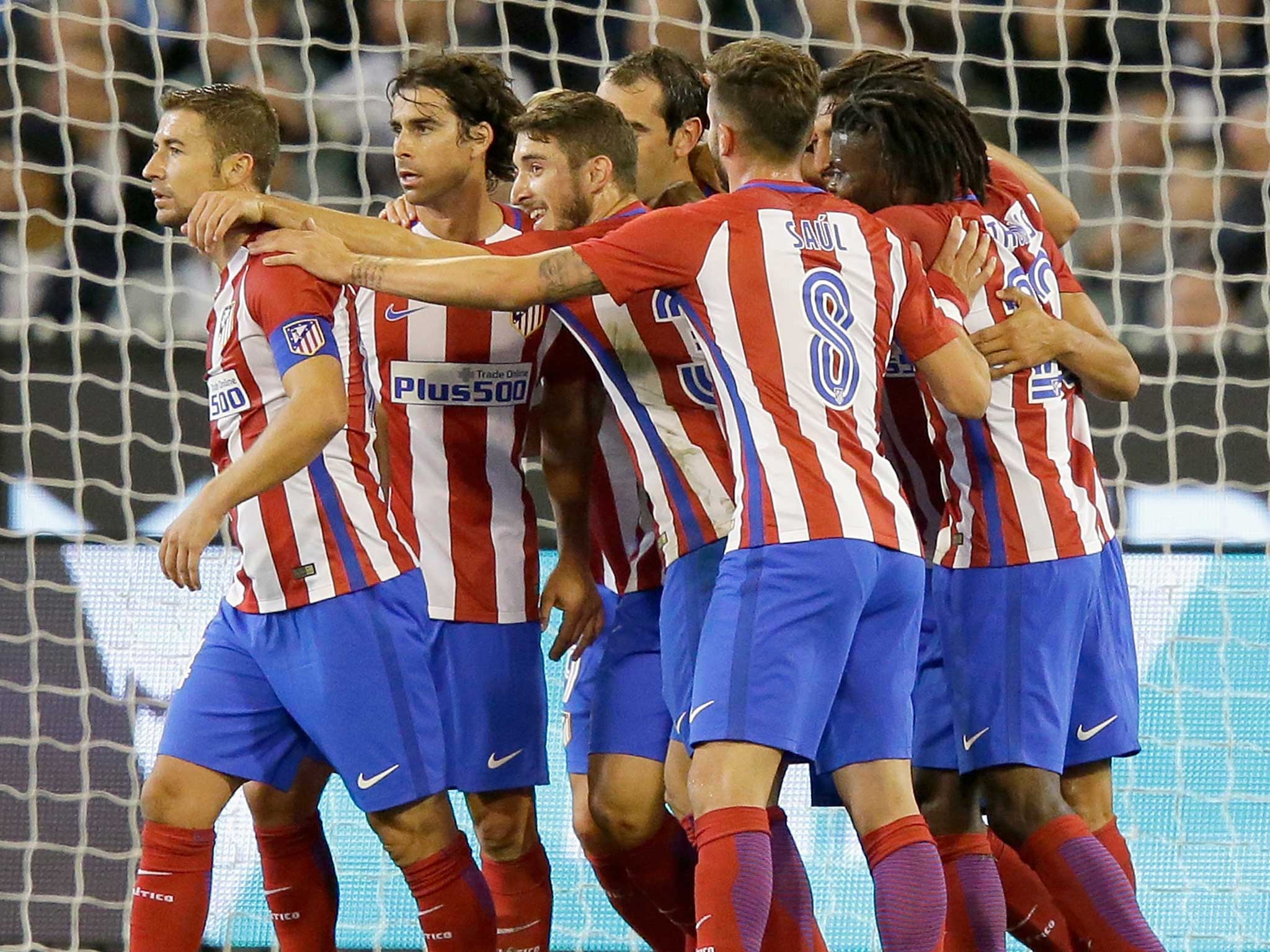 Diego Godin is mobbed by his team-mates after putting Atletico ahead