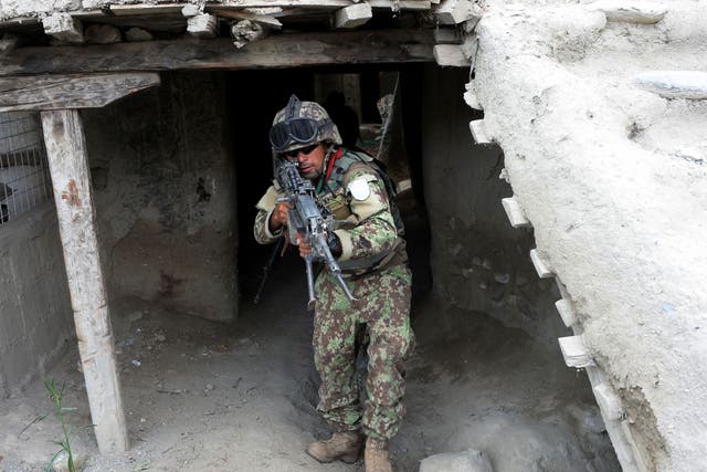 An Afghan security force member takes part in a patrol in Kot District in eastern Nangarhar province