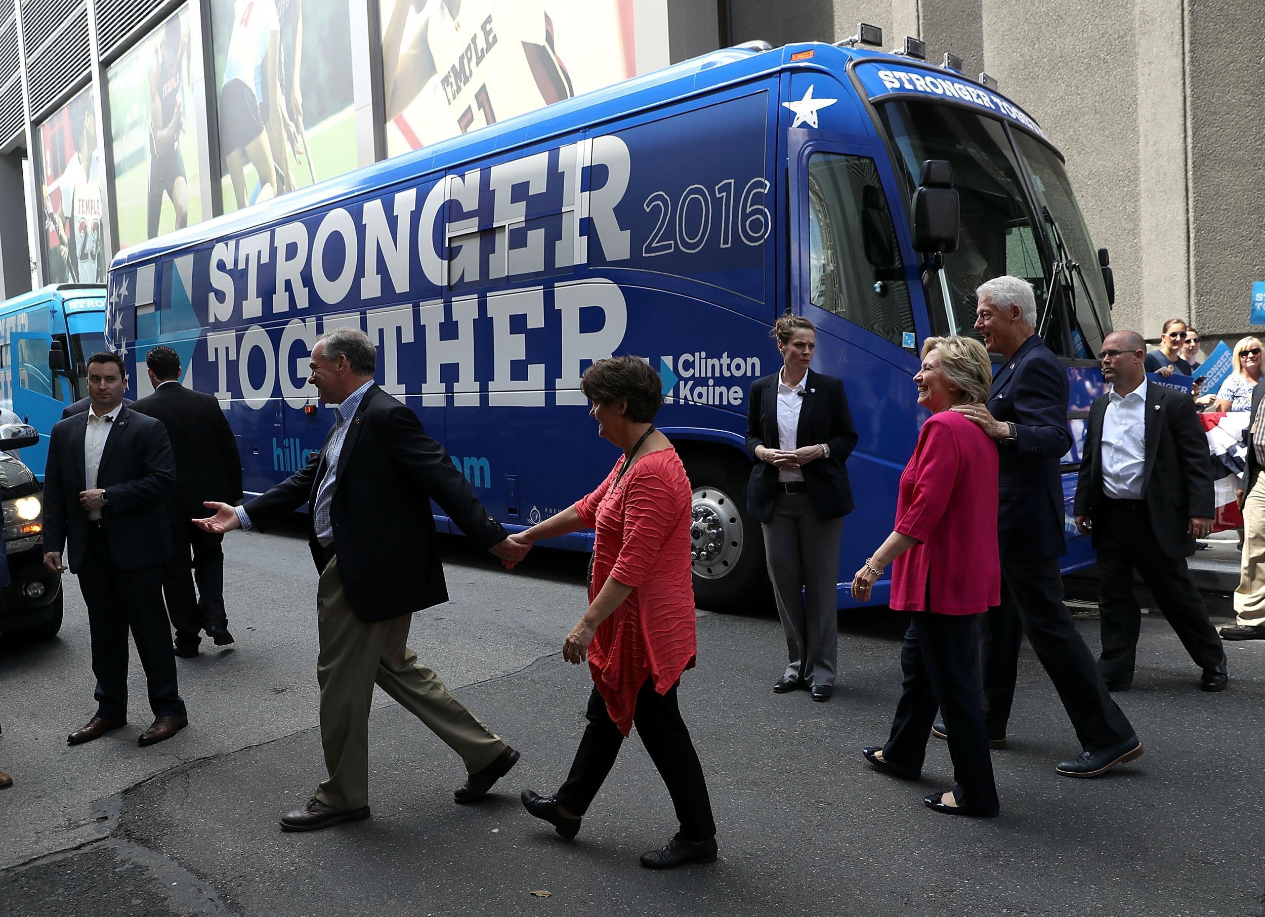 Clinton and Kaine, with their spouses, prepare to board a campaign bus out of Philadelphia