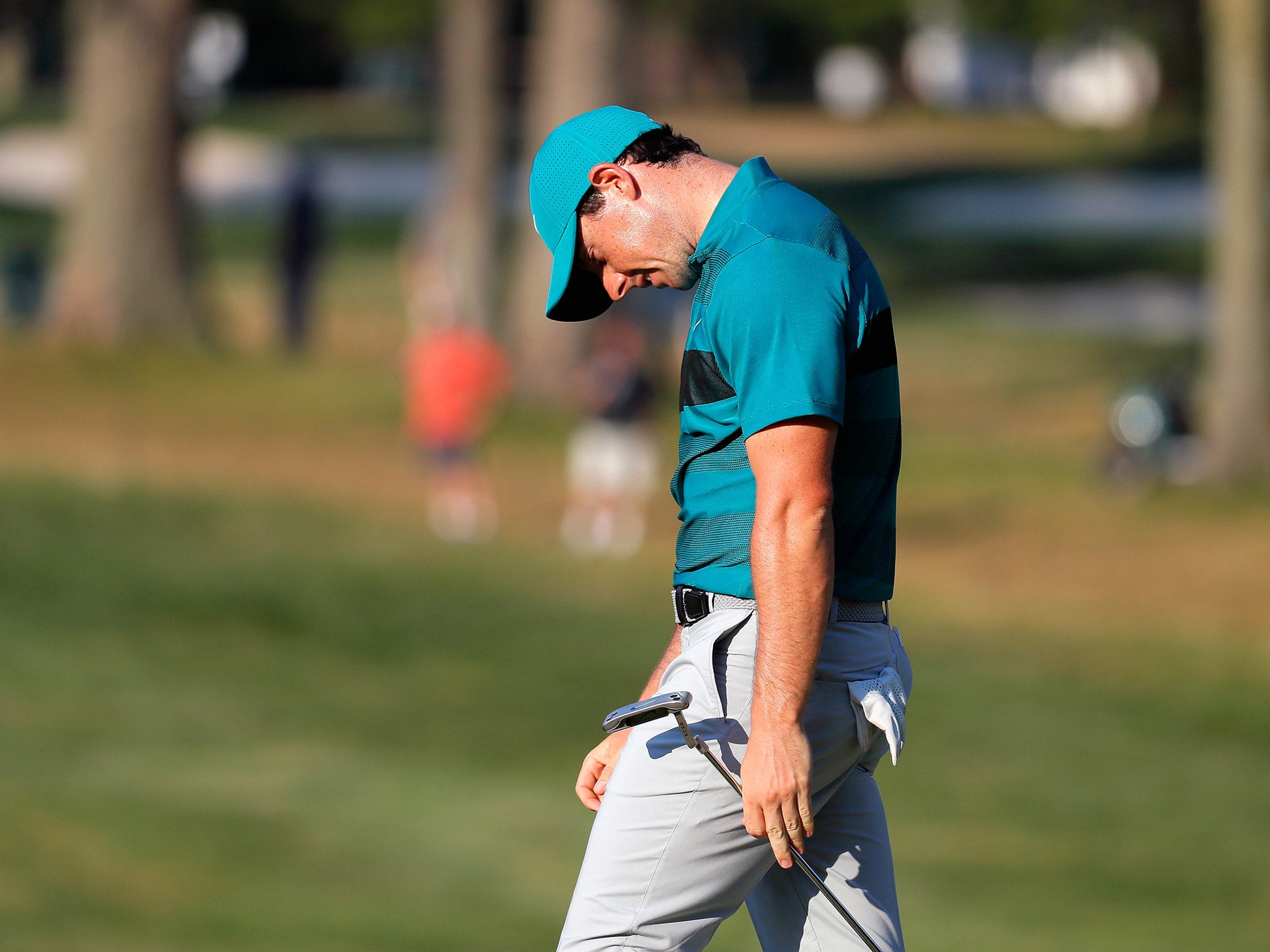 Rory McIlroy reacts to a missed birdie putt on 15