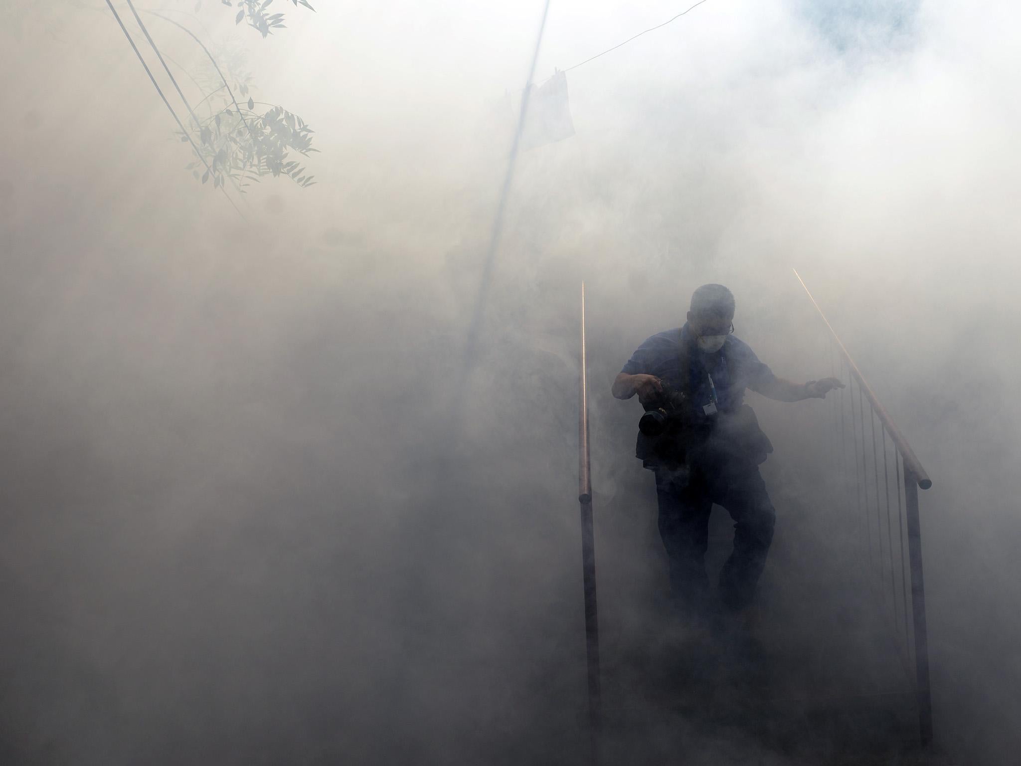 Health ministry employees fumigate against the Aedes aegypti mosquito to prevent the spread of the Zika virus in El Salvador in 2016