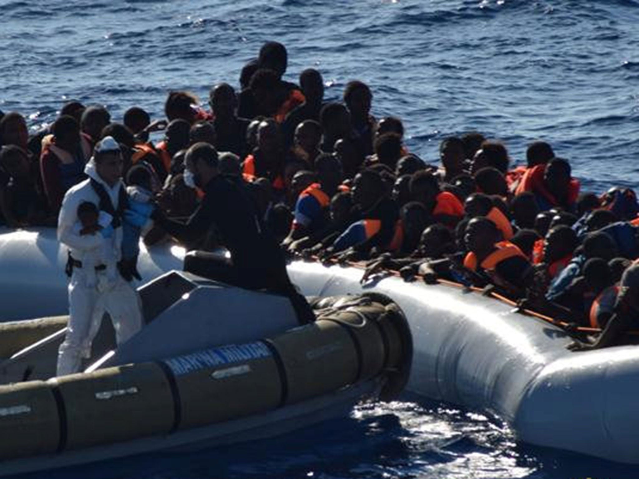 Babies are taken off a boat during a refugee rescue operation off the coast of Sicily last month