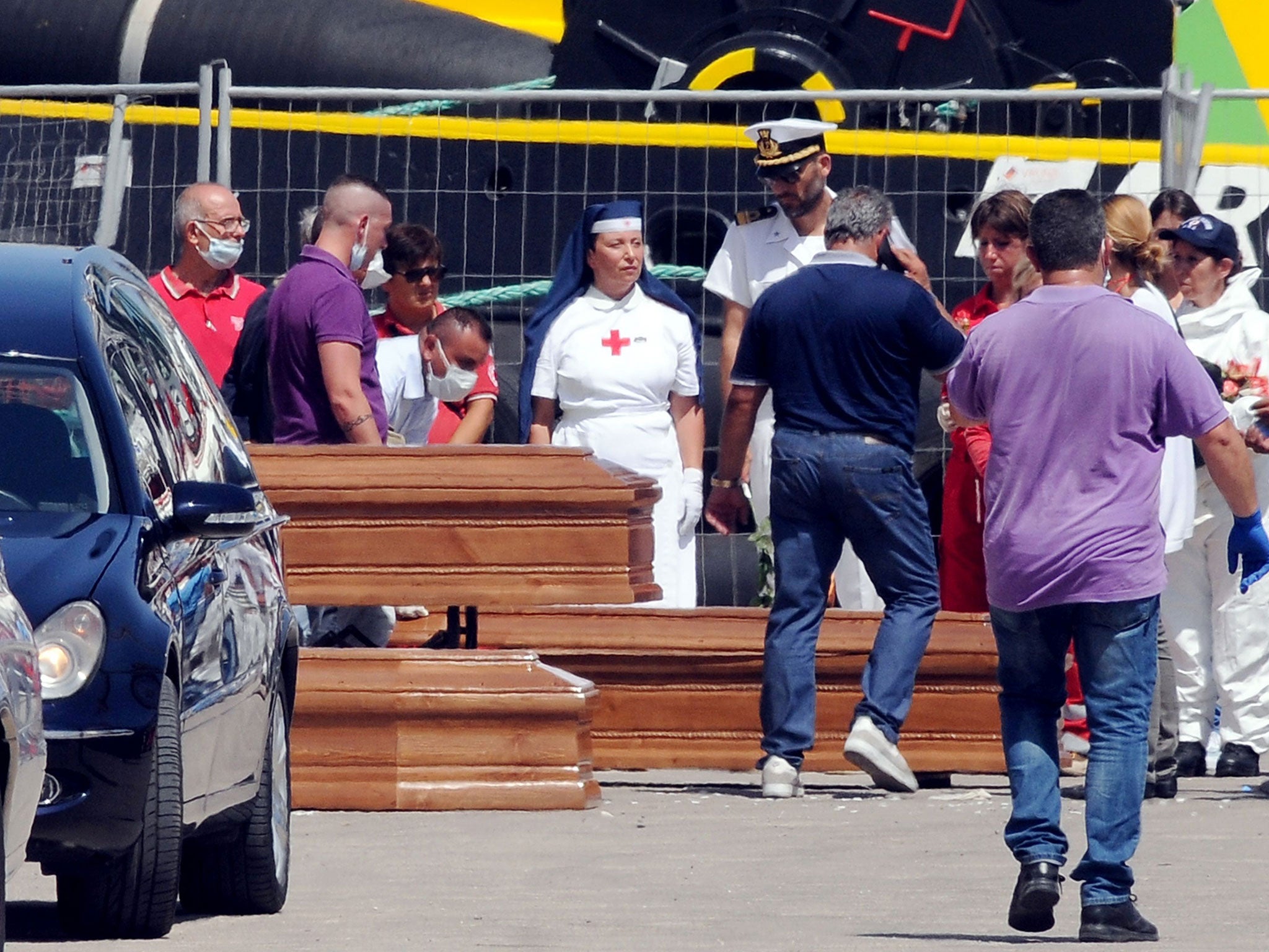 Coffins containing the bodies of 22 refugees who suffocated and drowned on a refugee boat in Trapani on July 22, 2016.