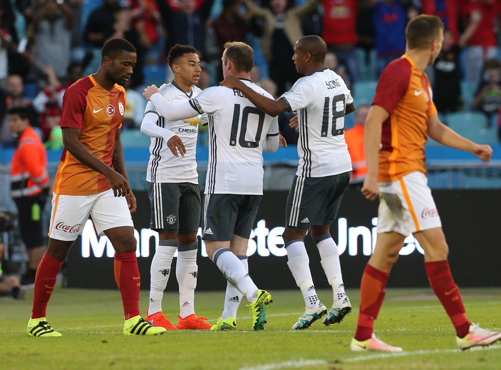 Wayne Rooney celebrates with Jesse Lingard and Ashley Young after scoring his second goal