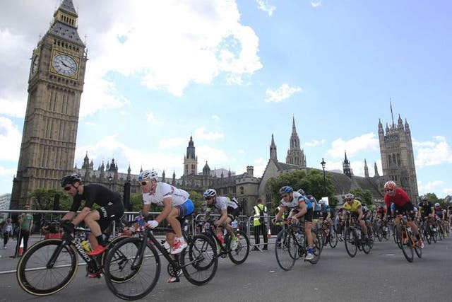 Cyclists pass the Palace of Westminster in the latter stages of the Prudential Ride 100