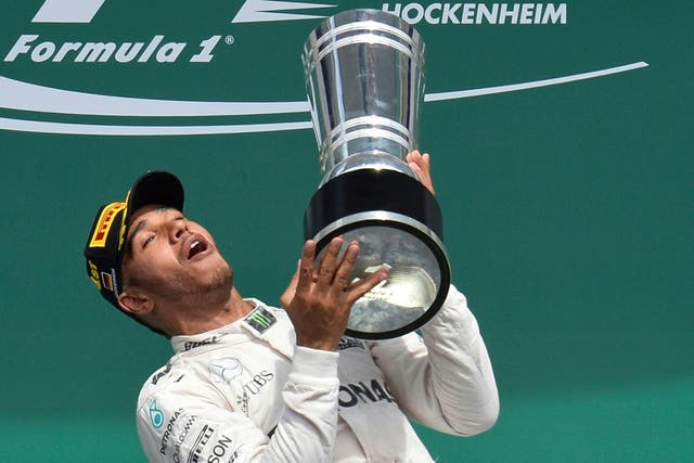 Lewis Hamilton lifts the trophy after winning the German Grand Prix