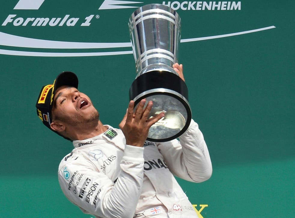 Lewis Hamilton lifts the trophy after winning the German Grand Prix