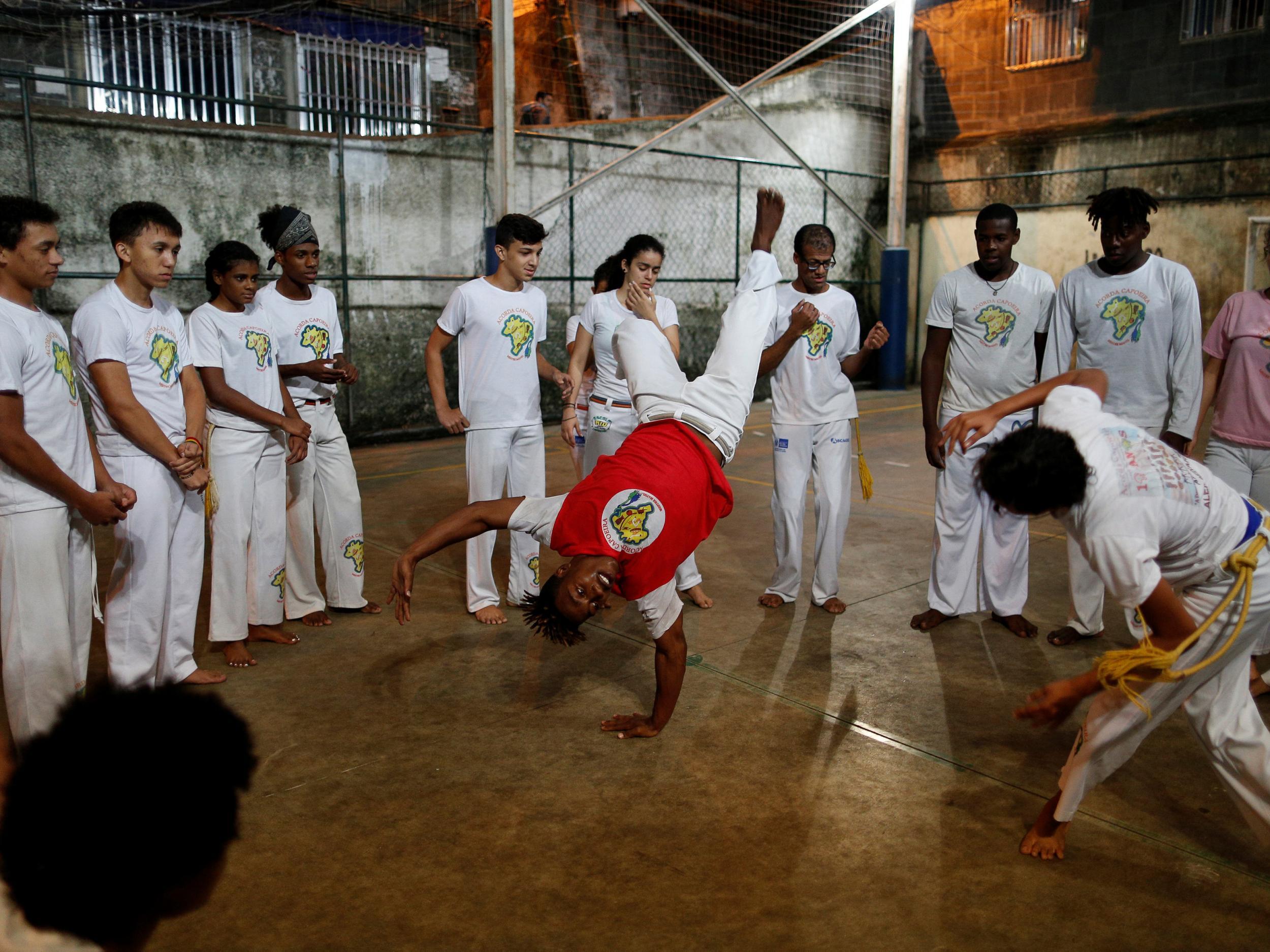 Members of the Acorda Capoeira group train at a local school