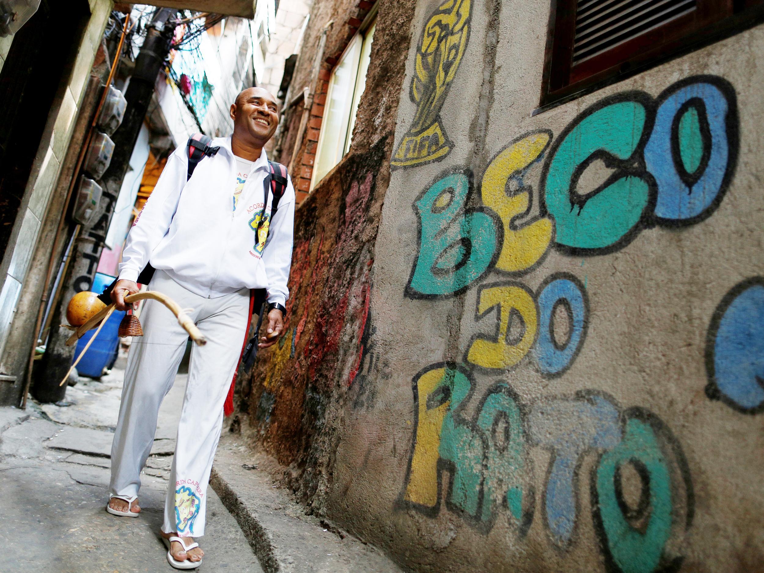 Manoel Pereira Costa, known as "Master Manel", walks in the Rocinha favela